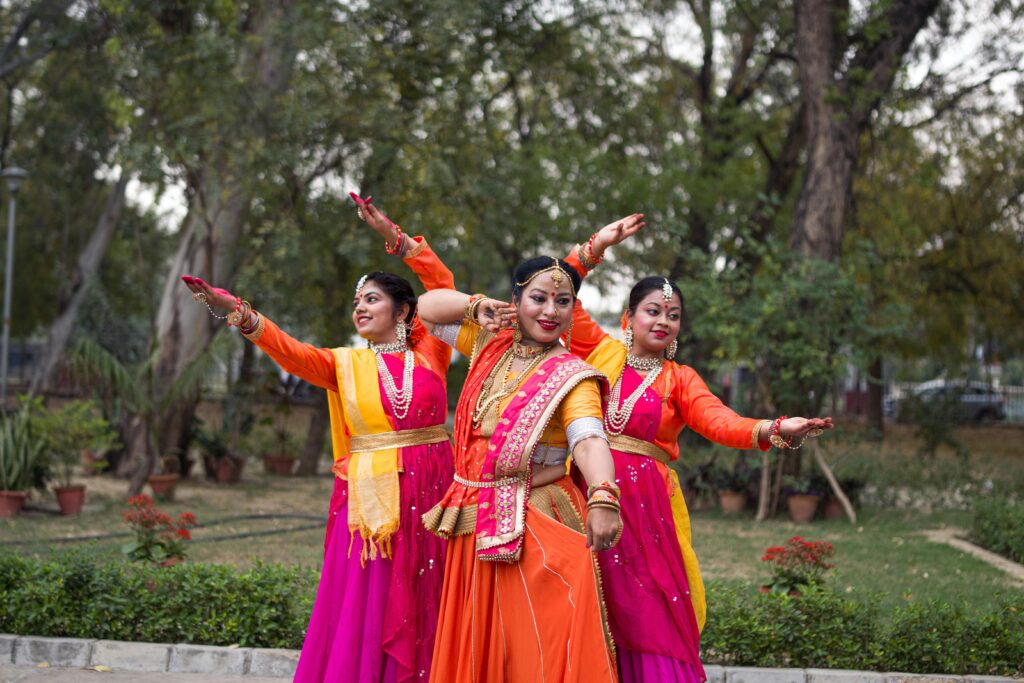 Vibrant display of traditional Indian dance by women in Kanpur, India, showcasing cultural attire.